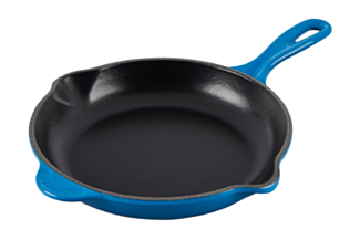 A Le Creuset Signature Skillet 9 in Marseille blue over a white background.