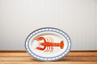 Golden Rabbit Lobster Oval Platter sitting on a brown wooden table.